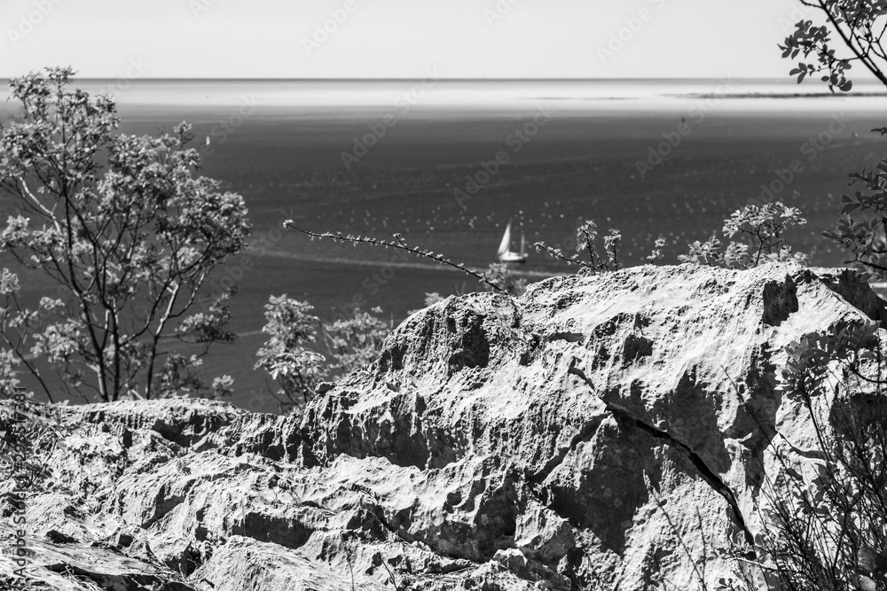 Gulf of Trieste. High cliffs Between boats, karst rocks and ancient castles. Black and white. Duino. Italy