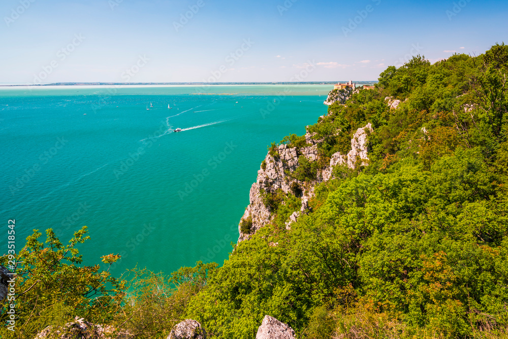 Gulf of Trieste. High cliffs Between boats, karst rocks and ancient castles. Duino. Italy