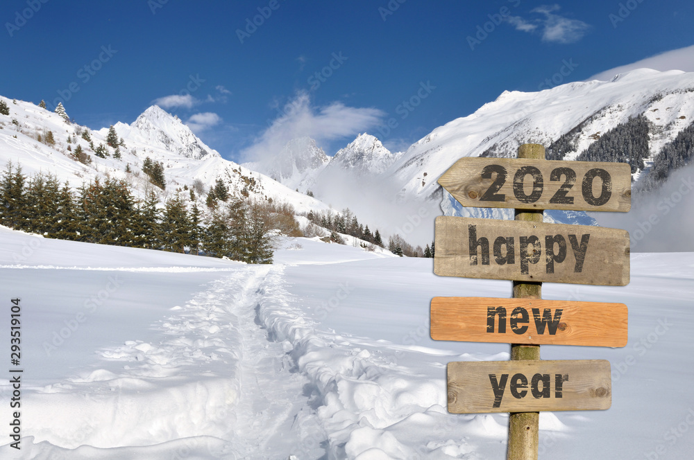 2020 happy new year written on a postsign in the snow on white mountain background