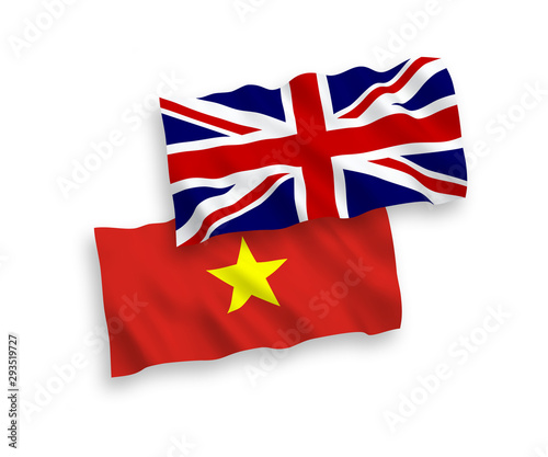 National vector fabric wave flags of Great Britain and Vietnam isolated on white background. 1 to 2 proportion.