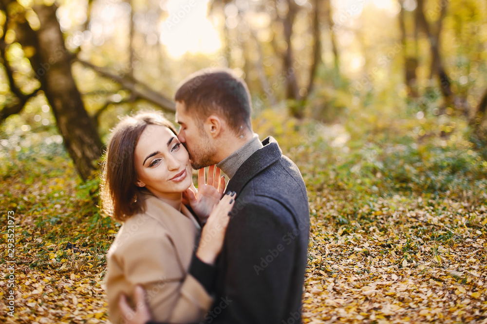 lovely couple walking around the park during autumn lovely couple walking around the park during autumn