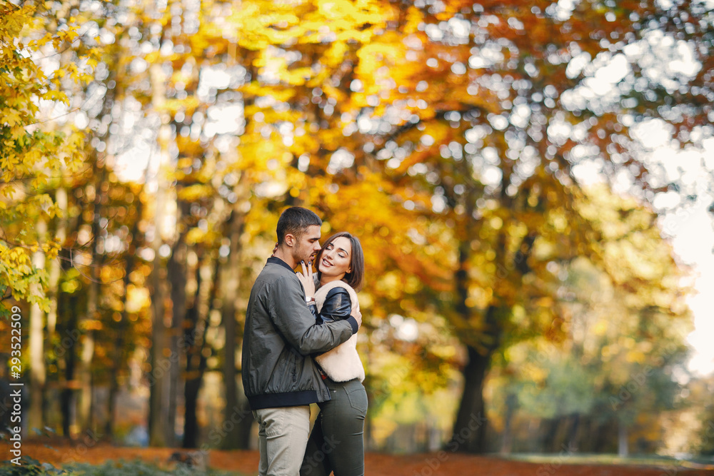 lovely couple walking around the park during autumn lovely couple walking around the park during autumn