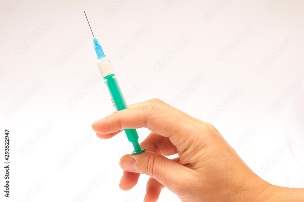 Syringe in hand Syringe in hand