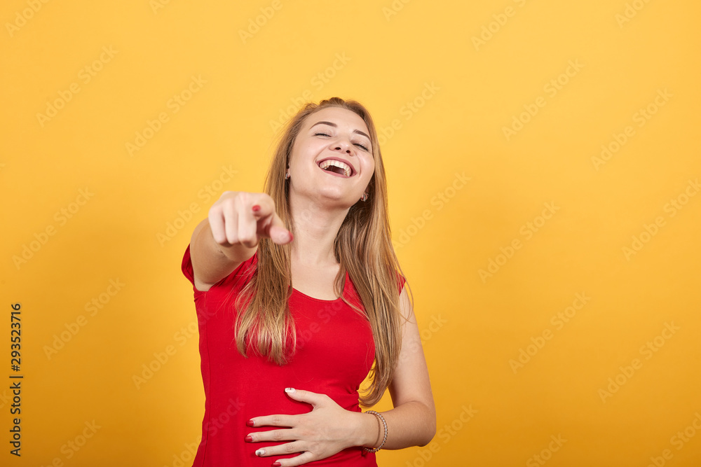 young blonde girl in red t-shirt over isolated orange background shows emotions young blonde girl in red t-shirt over isolated orange background shows emotions