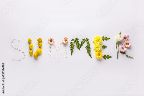 Word SUMMER made of flowers and leaves on white background