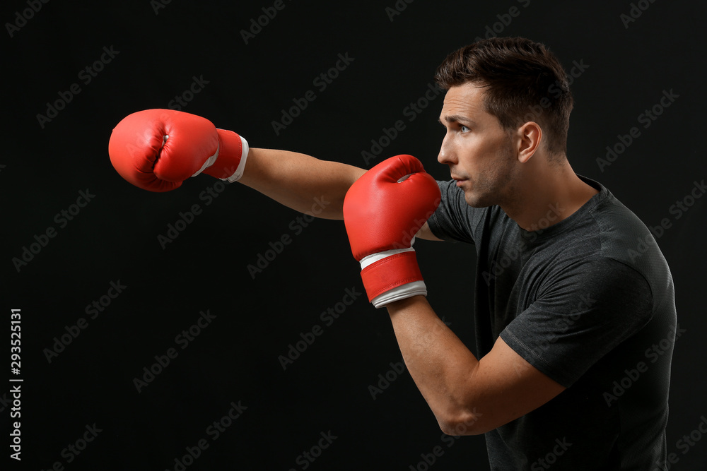 Sporty male boxer on dark background Sporty male boxer on dark background
