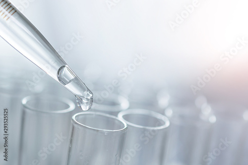 dropping liquid to test tubes, science laboratory research and development concept