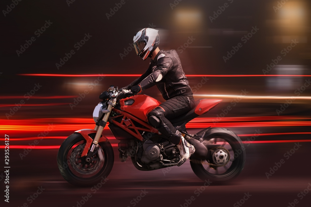 Motorcycle rider racing in red colors with motion blur