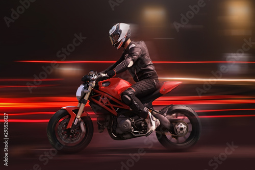 Motorcycle rider racing in red colors with motion blur © Alexey Kuznetsov