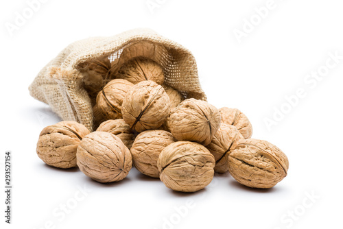 pile of walnuts in juta bag on white background