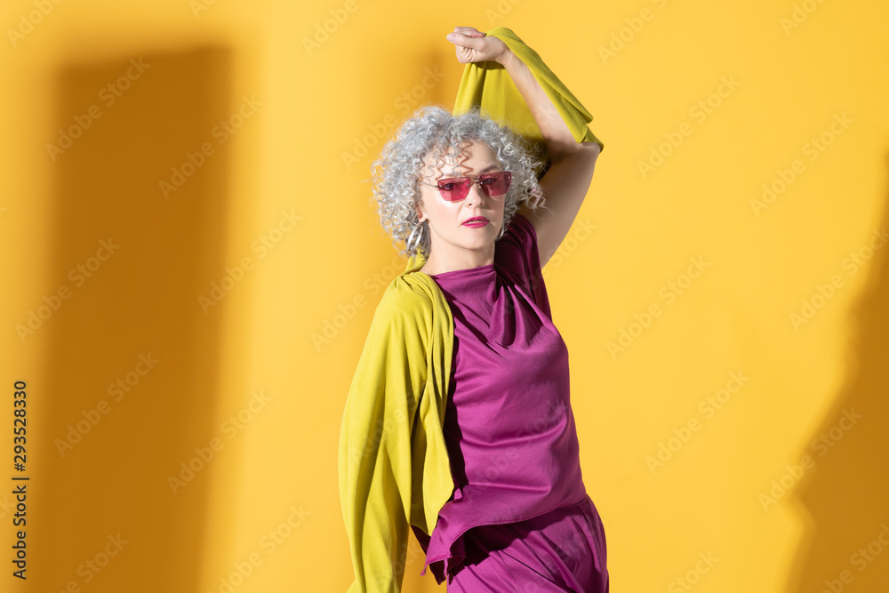 Beautiful woman wearing bright clothing and sunglasses