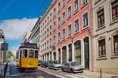 Tourist yellow tram rides down the slopes at Bairro Alto neighborhood, Lisbon, Portugal