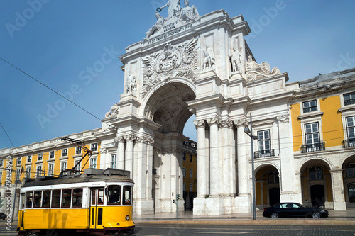 Yellow tram in front of the Triumphal Arch in the Praça do Comércio, Lisbon, Portugal