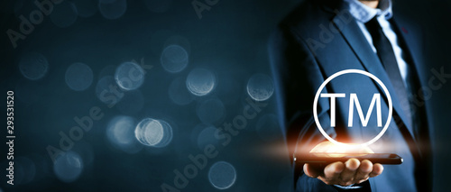 businessman holds the phone and with text tm