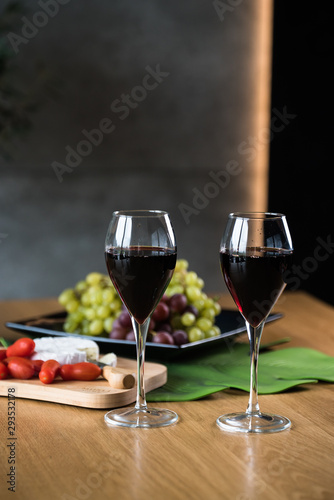 Waiter pouring red wine into wineglass. 