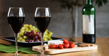 Waiter pouring red wine into wineglass. 