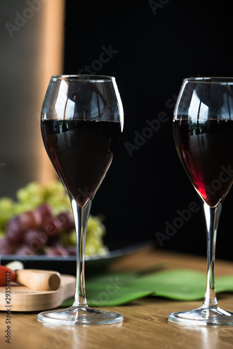 Waiter pouring red wine into wineglass. 