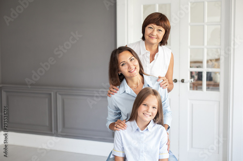 Three smiling womans of different ages stands in a row. Selective focus