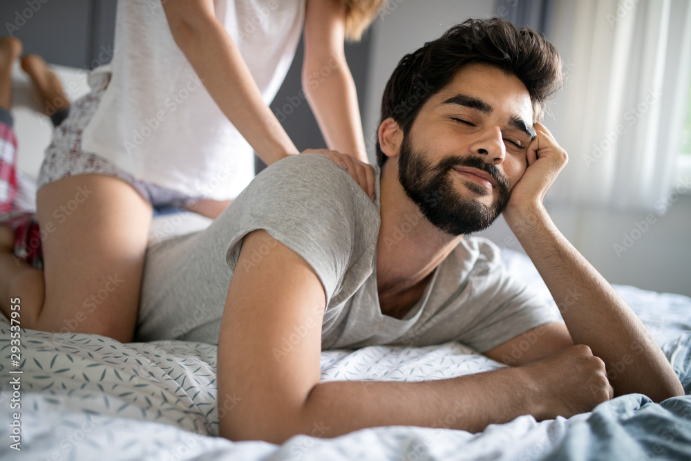 Happy young couple making massage in bedroom Happy young couple making massage in bedroom