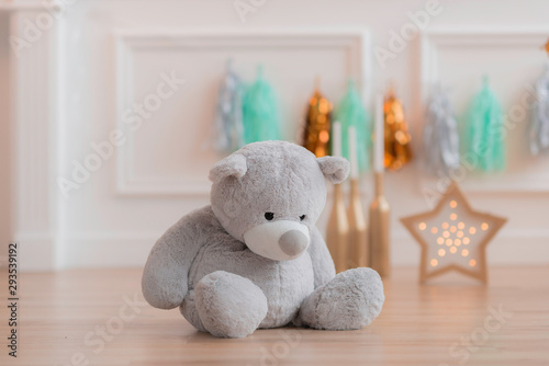 Teddy bear in colourful decoration closeup on the background