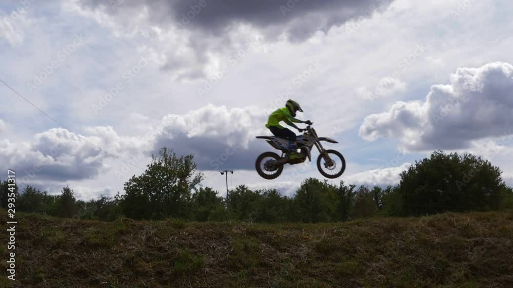 Silhouette shot of motocross racer jumping above sky. Slow motion. Silhouette shot of motocross racer jumping above sky. Slow motion.