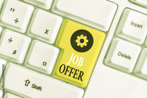 Conceptual hand writing showing Job Offer. Concept meaning A peron or company that gives opurtunity for one s is employment White pc keyboard with note paper above the white background photo