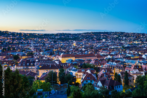 Germany, Magical summer sunset sky over urban cityscape of stuttgart city houses and roofs, aerial view from above over illuminated skyline © Simon
