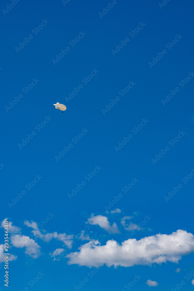 Weather station airship floating with deep blue sky in the background. Weather station airship floating with deep blue sky in the background.