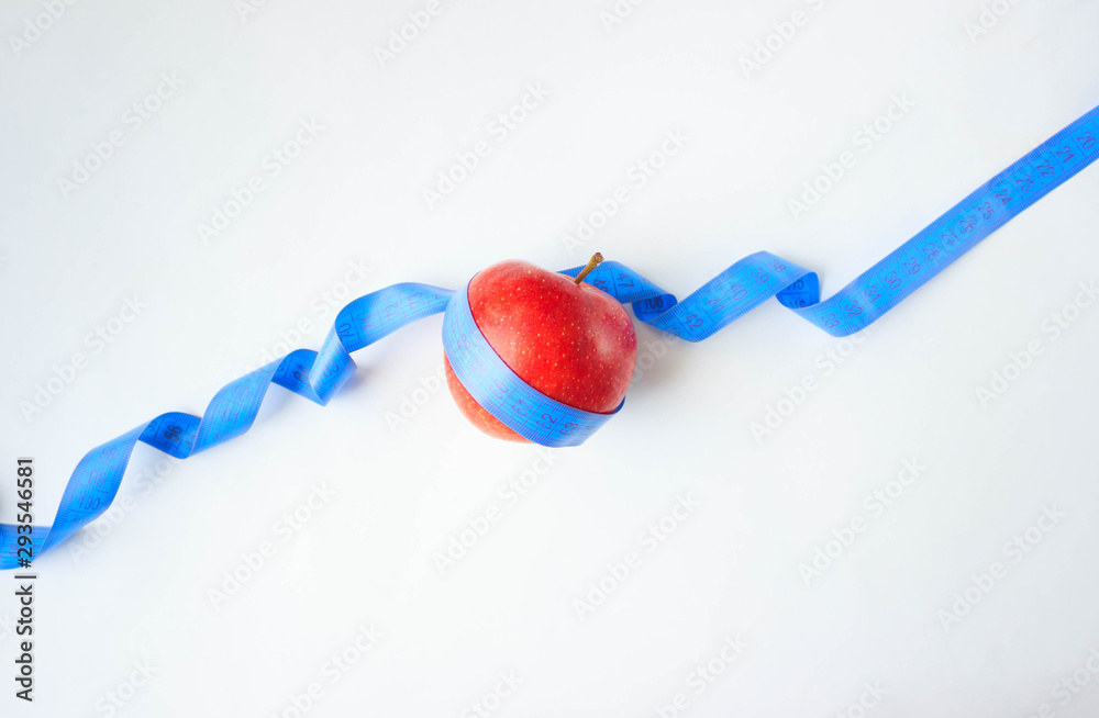 red Apple, wrapped in a centimeter, on a white background, weight loss, concept red Apple, wrapped in a centimeter, on a white background, weight loss, concept