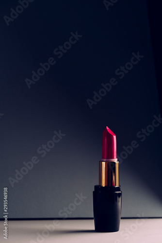 Pink lipstick on modern background. Product and make up concept photo