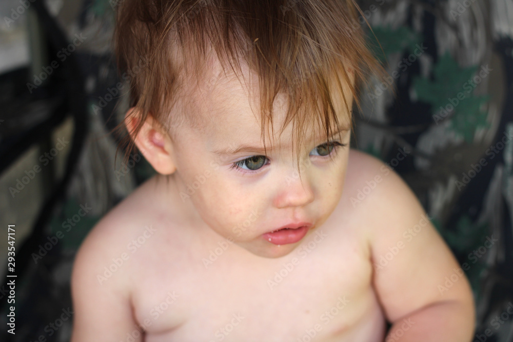 little white pensive child with tousled hair without clothing little white pensive child with tousled hair without clothing