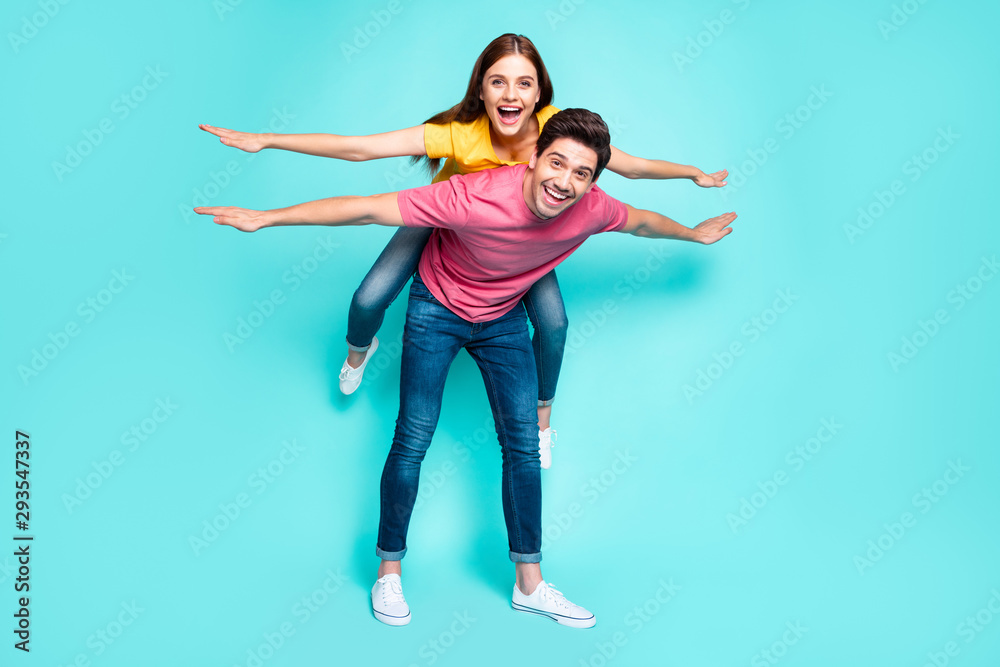 Full length body size view of nice attractive playful funny cheerful cheery couple guy carrying girl having fun like flying isolated over bright vivid shine vibrant green turquoise background - obrazy, fototapety, plakaty 