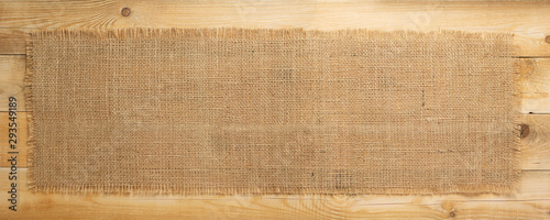 burlap hessian sacking on wooden background photo