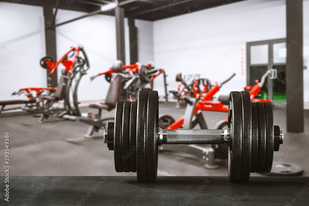 Obraz premium Gym interior and dumbbells on board with free space for your decoration. 