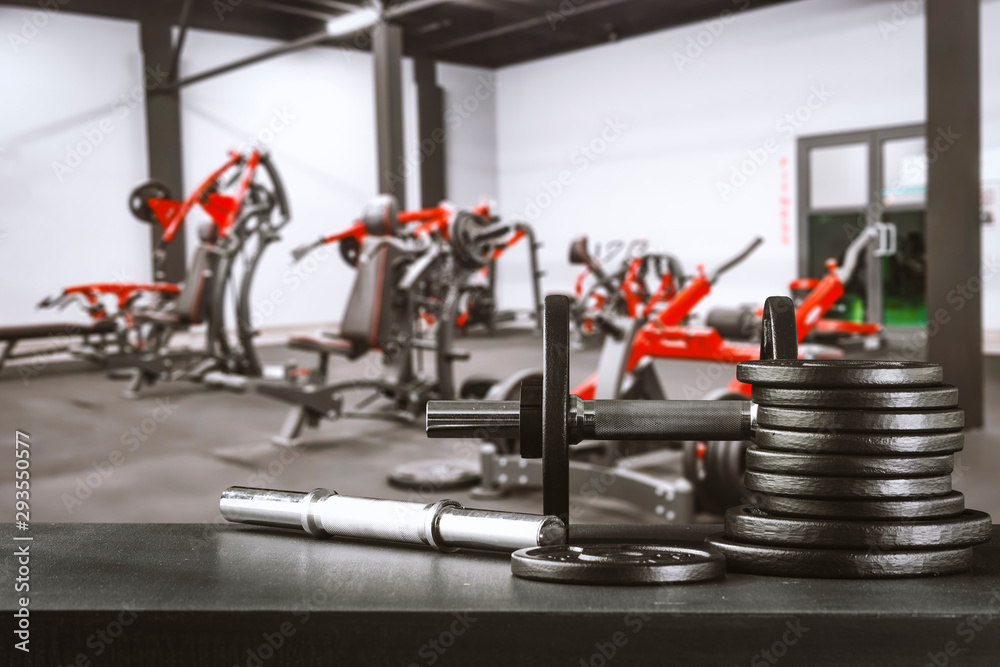 Obraz premium Gym interior and dumbbells on board with free space for your decoration. 