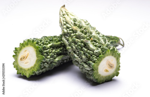 Bitter gourd cut in halves on isolated white background