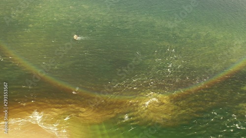 Drone view of 360 degree full circle rainbow reflecting on the water of Lough Foyle in Ireland at sunrise photo