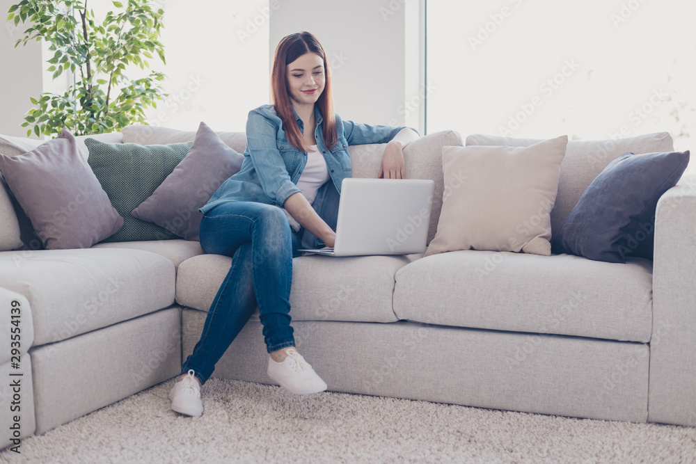Photo of business lady holding notebook working at home speaking skype with colleagues sitting sofa wearing jeans outfit apartment indoors Photo of business lady holding notebook working at home speaking skype with colleagues sitting sofa wearing jeans outfit apartment indoors