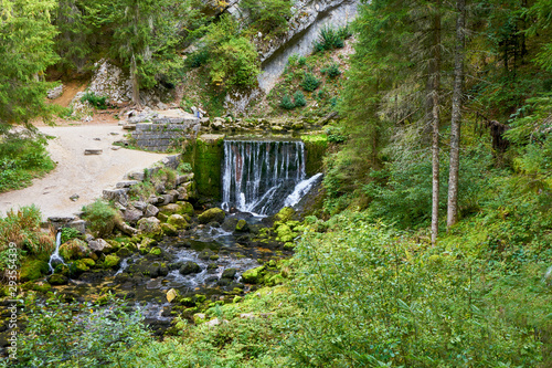 Waterfall at Source du Doubs Mouthe Franche Comté France with Green Plants