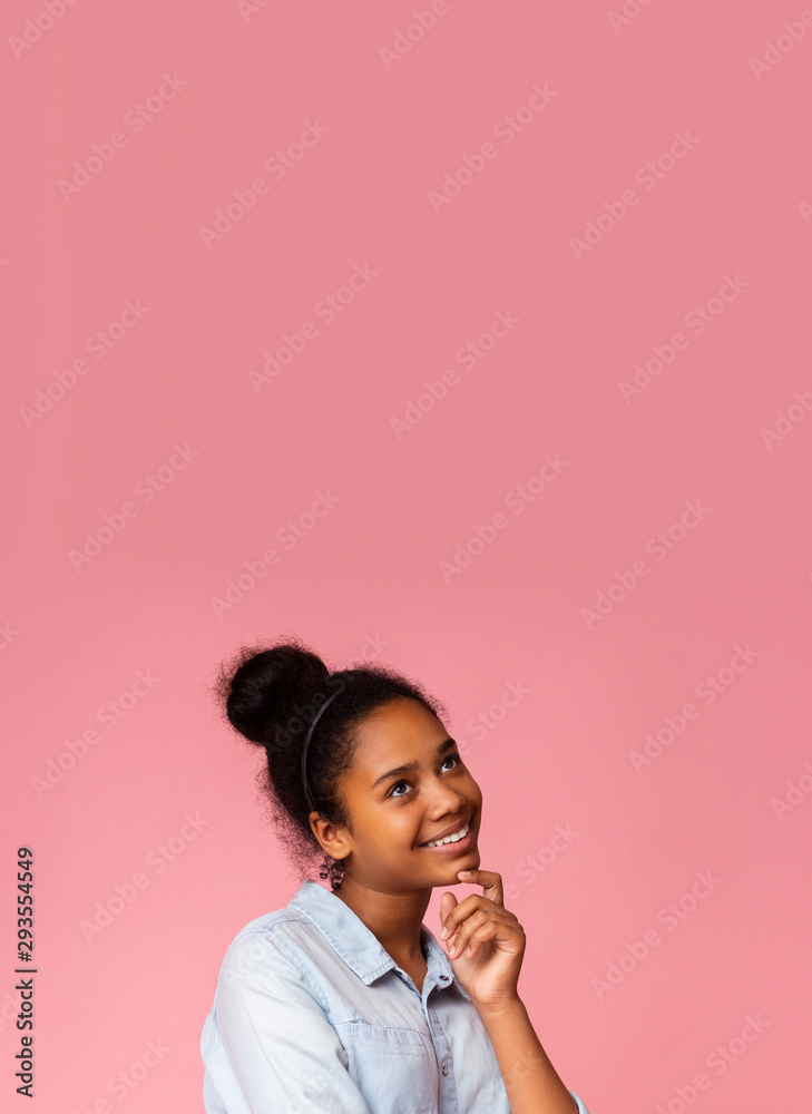 Daydreaming. Pensive black girl touching her chin and looking upwards Daydreaming. Pensive black girl touching her chin and looking upwards