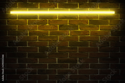 Background texture of empty red brick wall with yellow neon light lamp, 80s style glow