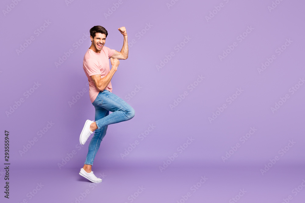 Full length body size profile side view of his he nice attractive fit cheerful cheery glad guy wearing pink tshirt celebrating holiday isolated on violet purple lilac pastel color background Full length body size profile side view of his he nice attractive fit cheerful cheery glad guy wearing pink tshirt celebrating holiday isolated on violet purple lilac pastel color background