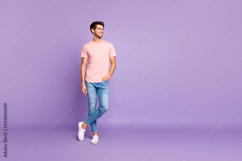 Full length body size view of his he nice attractive fit cheerful cheery content guy wearing pink tshirt standing enjoying lifestyle isolated on violet purple lilac pastel color background Full length body size view of his he nice attractive fit cheerful cheery content guy wearing pink tshirt standing enjoying lifestyle isolated on violet purple lilac pastel color background