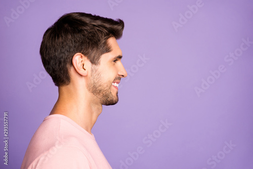 Close-up profile side view portrait of his he nice attractive well-groomed cheerful cheery brunet bearded guy wearing pink tshirt copyspace isolated over violet purple lilac pastel color background