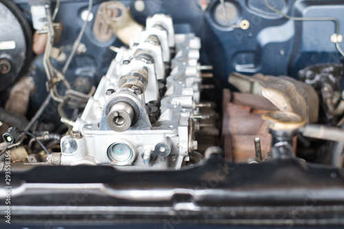 Close up of car engine parts detail during repair at garage.