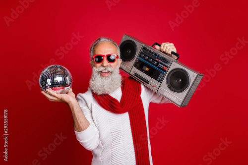 Portrait of his he nice cool handsome cheerful glad positive gray-haired man in pullover sweater having fun celebratory occasion nightclub disco isolated on bright vivid shine red background