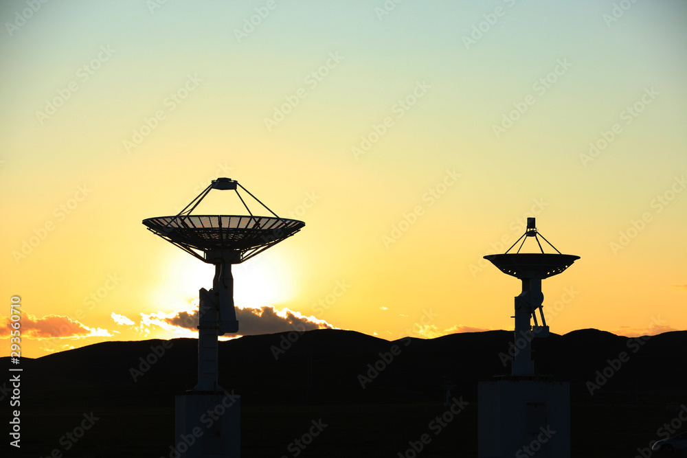 The silhouette of a radio telescope