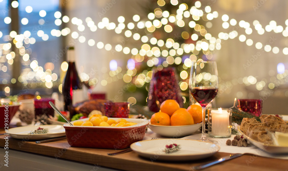 christmas dinner and eating concept - food and drinks on table at home - obrazy, fototapety, plakaty 