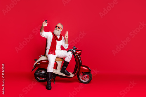 Portrait of his he nice attractive stylish trendy confident content optimistic gray-haired man taking making selfie showing v-sign isolated over bright vivid shine red background