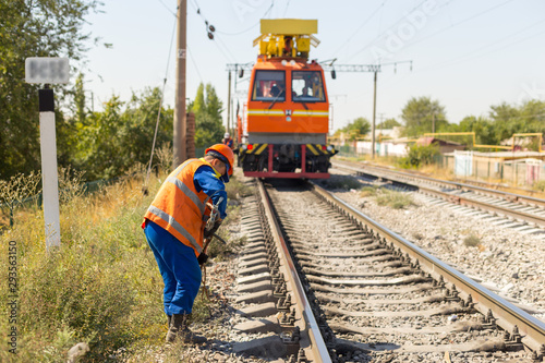 workers replace old wires with new ones in the railway using equipment